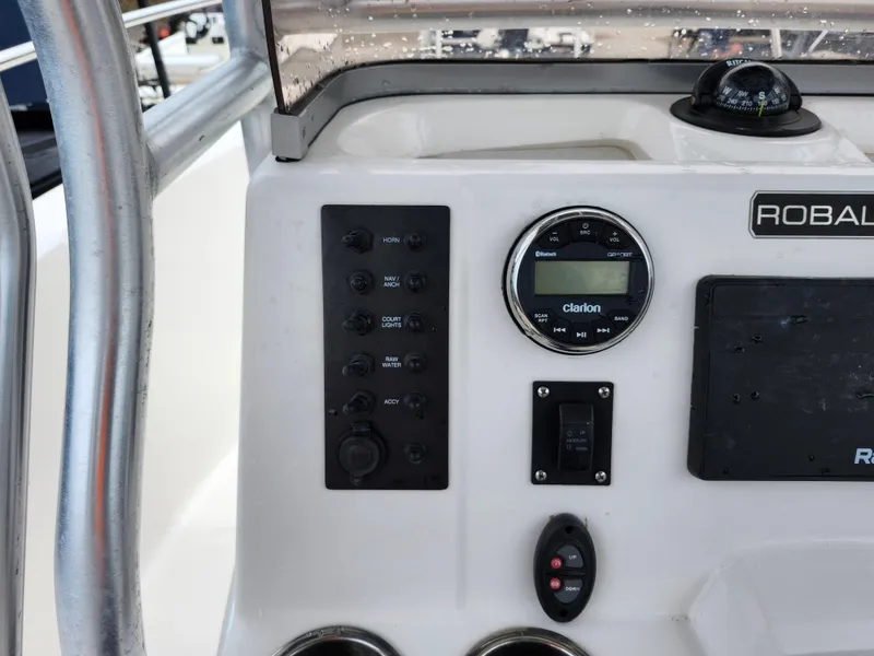 Slide: The Image of 2018 Robalo R180 Center Console dashboard with controls and compass. - 18
