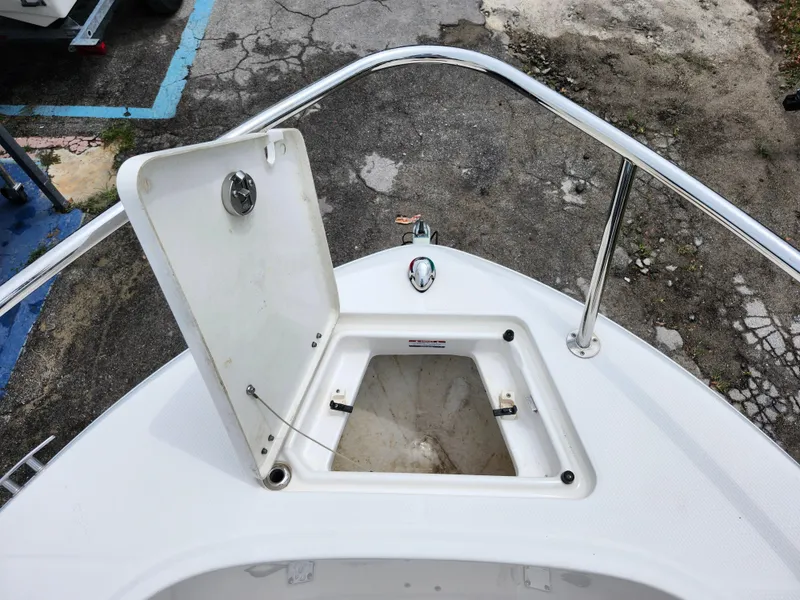 Slide: The Image of 2018 Robalo R180 Center Console boat with open storage compartment on deck. - 27