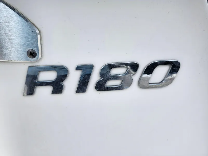 Slide: The Image of Chrome "R180" emblem on 2018 Robalo R180 Center Console boat. - 28