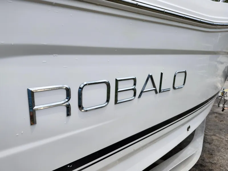 Slide: The Image of 2018 Robalo R180 Center Console boat, close-up of logo on white hull. - 29