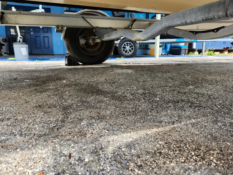 Slide: The Image of 2018 Robalo R180 Center Console trailer wheel on asphalt surface. - 30