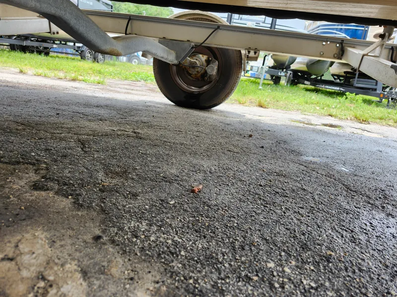 Slide: The Image of Trailer wheel of 2018 Robalo R180 Center Console boat on asphalt surface. - 31