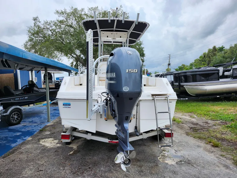 Slide: The Image of 2018 Robalo R180 Center Console boat with Yamaha 150 engine, parked outdoors. - 5