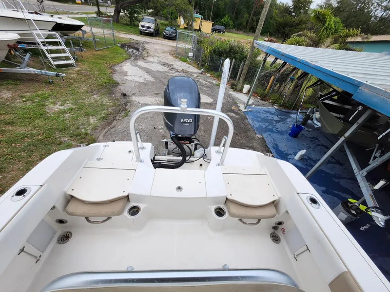 Slide: The Image of 2018 Robalo R180 Center Console boat with outboard motor, docked outdoors. - 7