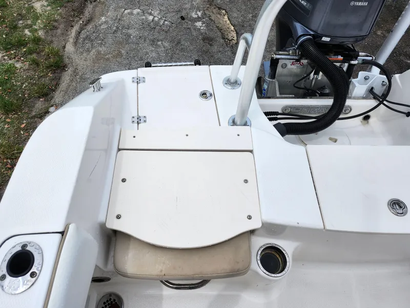 Slide: The Image of 2018 Robalo R180 Center Console boat deck with seating and storage compartments. - 8