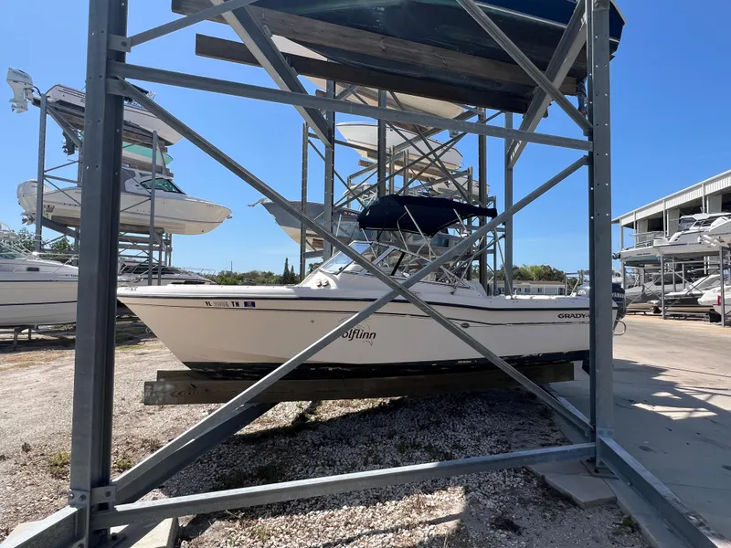 Slide: The Image of 2006 Grady-White Freedom 225 boat stored on a metal rack in a marina. - 1