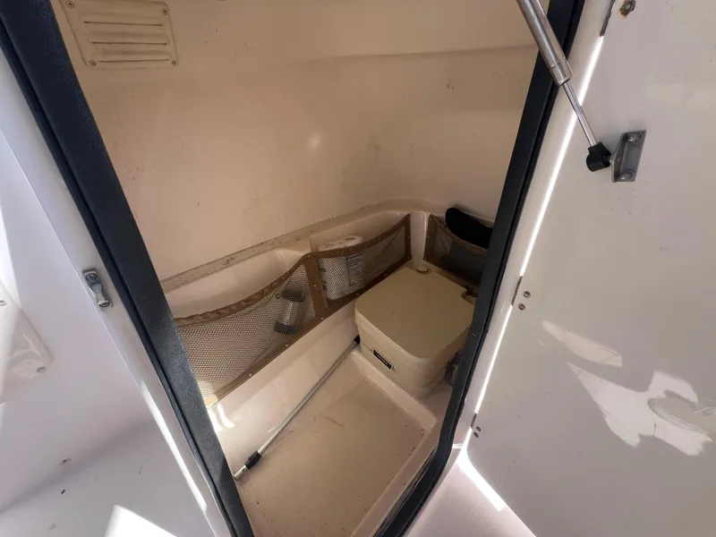 Slide: The Image of Interior of 2006 Grady-White Freedom 225 boat with storage and portable toilet. - 11