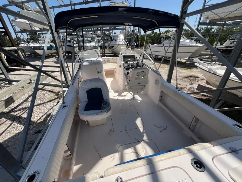 Slide: The Image of 2006 Grady-White Freedom 225 boat with seating and canopy, docked in a marina. - 12