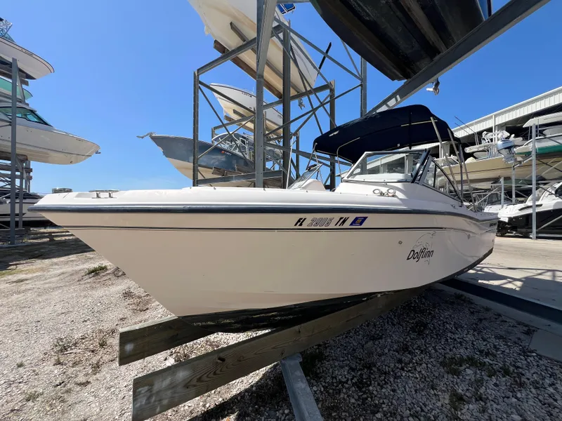 Slide: The Image of 2006 Grady-White Freedom 225 boat in dry storage, side view under clear blue sky. - 2