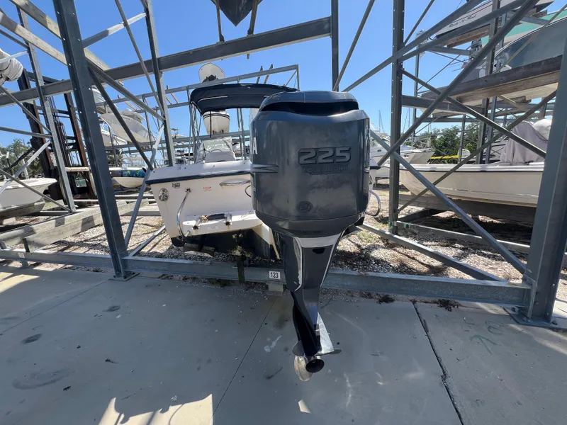 Slide: The Image of 2006 Grady-White Freedom 225 boat with outboard motor in storage rack. - 4