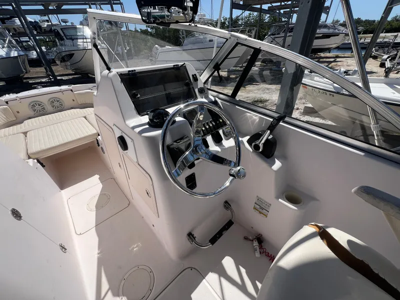 Slide: The Image of 2006 Grady-White Freedom 225 boat cockpit with steering wheel and controls. - 7
