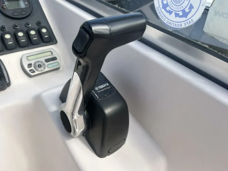 Slide: The Image of Throttle control on a 2008 Grady-White 225 Tournament boat dashboard. - 14