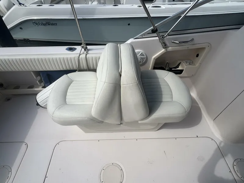 Slide: The Image of 2008 Grady-White 225 Tournament boat interior with white seating and sleek design. - 17