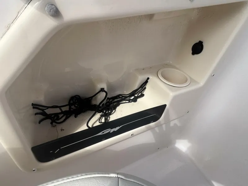 Slide: The Image of Storage compartment in a 2008 Grady-White 225 Tournament boat with cup holder. - 19
