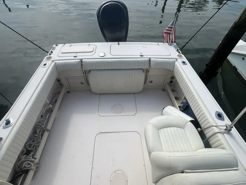 Slide: The Image of 2008 Grady-White 225 Tournament boat interior with seating and American flag. - 21