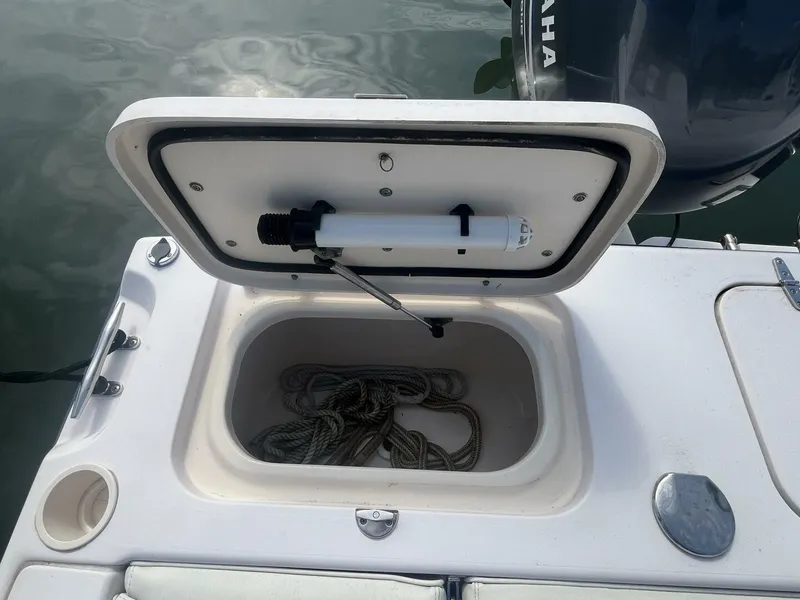 Slide: The Image of Open storage compartment on 2008 Grady-White 225 Tournament boat with coiled rope inside. - 24
