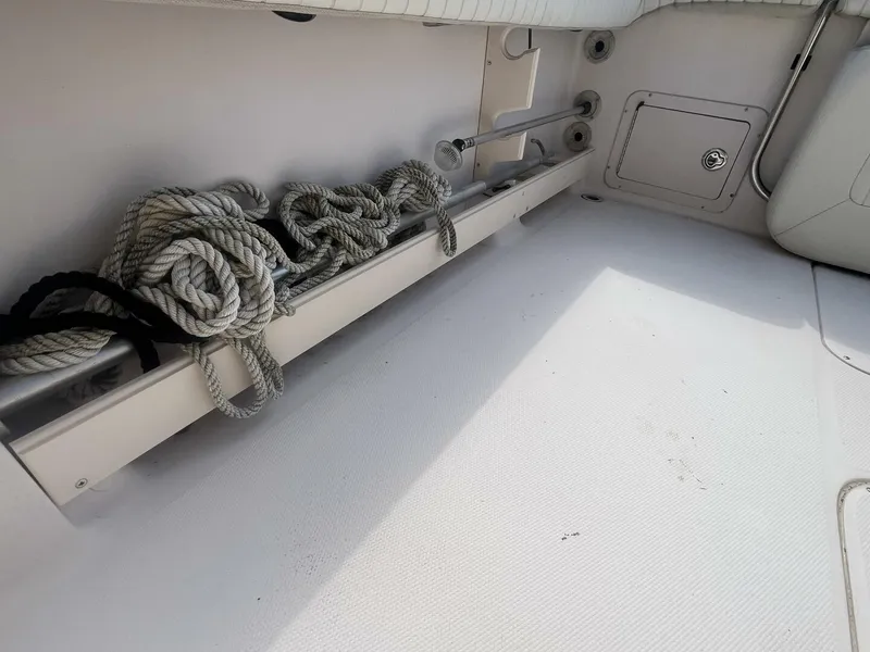 Slide: The Image of 2008 Grady-White 225 Tournament boat interior with coiled rope storage. - 26