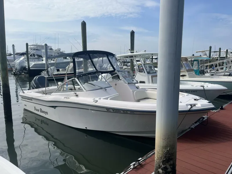 Slide: The Image of 2008 Grady-White 225 Tournament boat docked at marina under clear sky. - 3