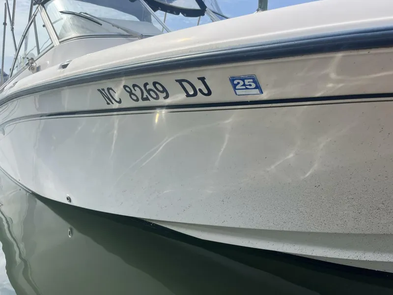 Slide: The Image of 2008 Grady-White 225 Tournament boat with registration NC 8269 DJ on water. - 6