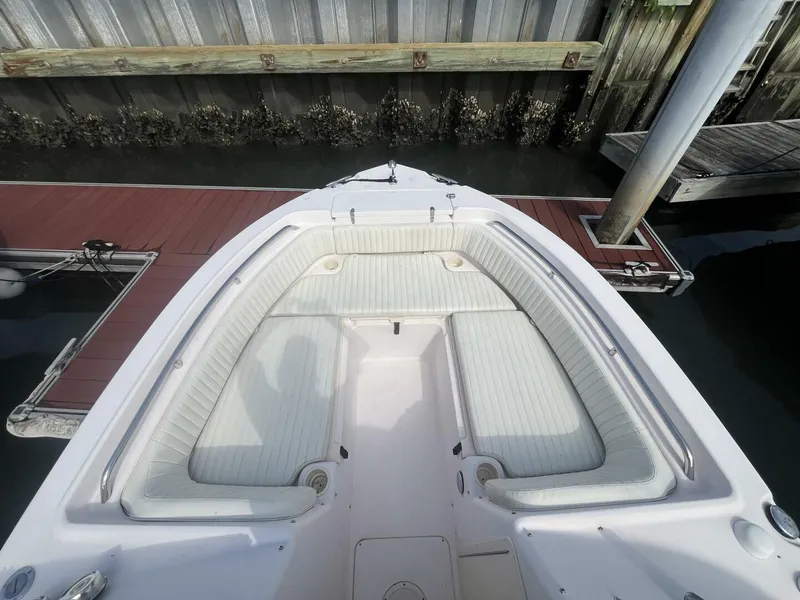 Slide: The Image of 2008 Grady-White 225 Tournament boat with spacious seating docked by wooden pier. - 7