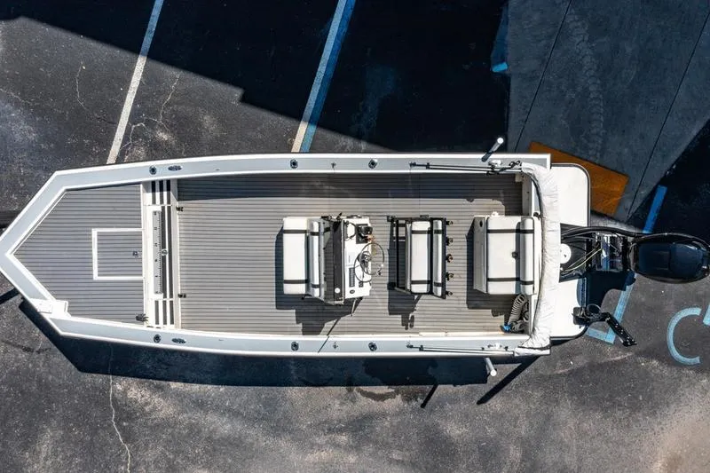 Slide: The Image of Overhead view of 2018 Encore Boat Works 25 Custom on pavement. - 10