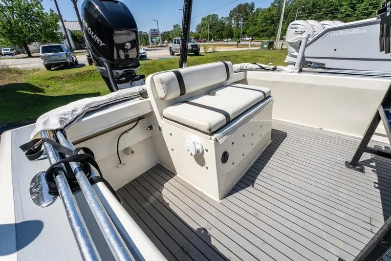 Slide: The Image of 2018 Encore Boat Works 25 Custom interior with cushioned seating and outboard motor. - 11