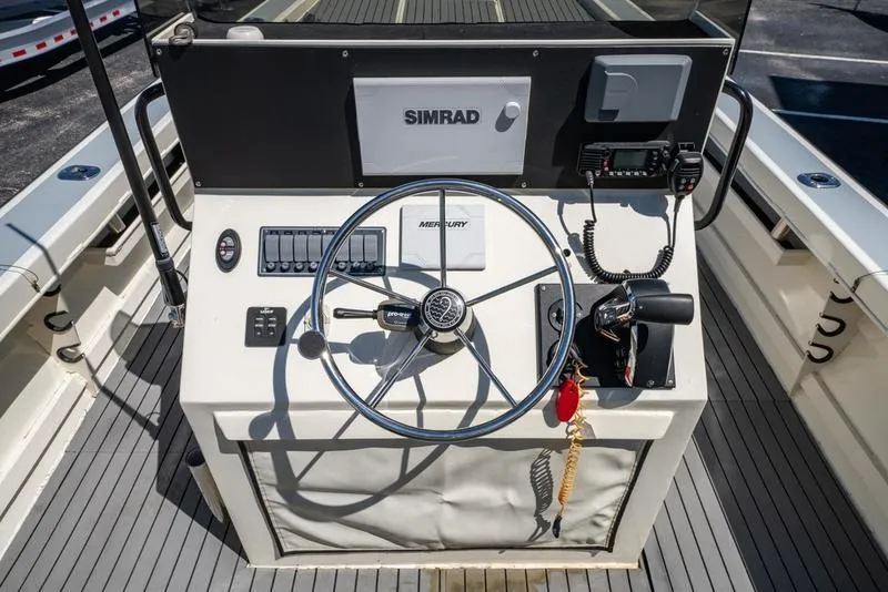 Slide: The Image of Control panel of 2018 Encore Boat Works 25 Custom with steering wheel and navigation equipment. - 14