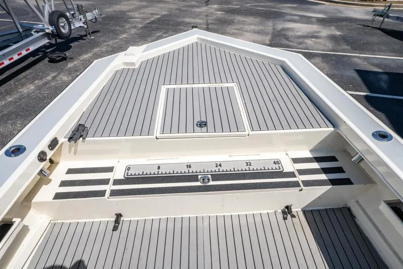 Slide: The Image of 2018 Encore Boat Works 25 Custom deck with measurement markings and storage hatch. - 18