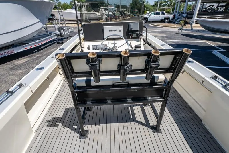 Slide: The Image of 2018 Encore Boat Works 25 Custom with rod holders and steering console, docked in a marina. - 21