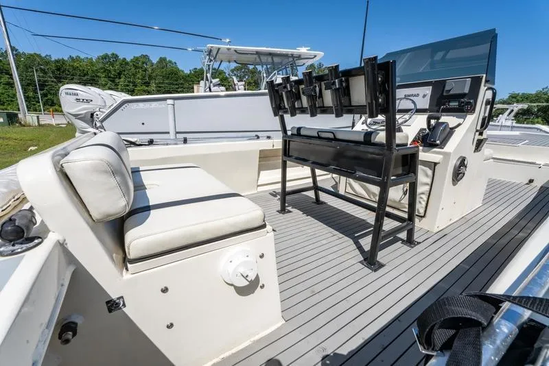 Slide: The Image of 2018 Encore Boat Works 25 Custom interior with seating and control panel, featuring modern design. - 23