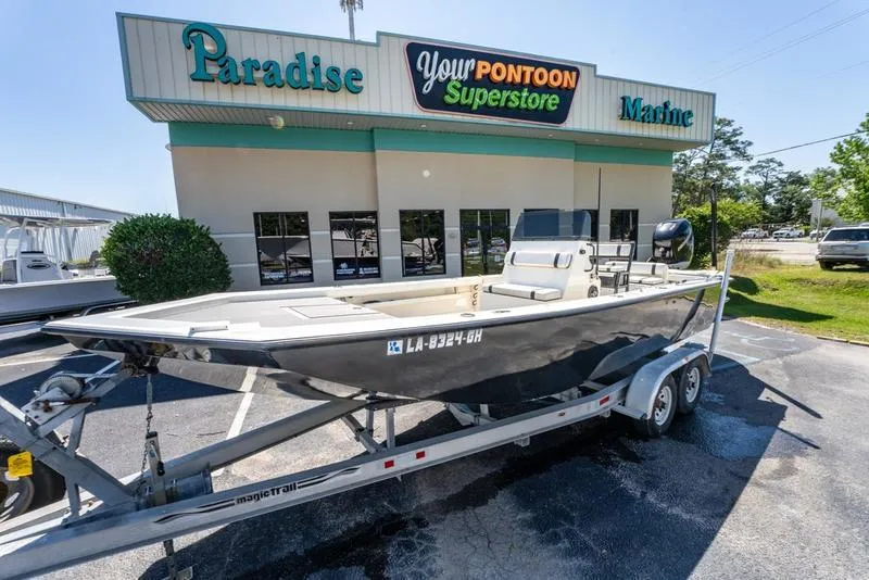 Slide: The Image of 2018 Encore Boat Works 25 Custom on trailer outside marine store. - 4