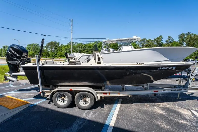 Slide: The Image of 2018 Encore Boat Works 25 Custom on trailer, parked outdoors under clear blue sky. - 6