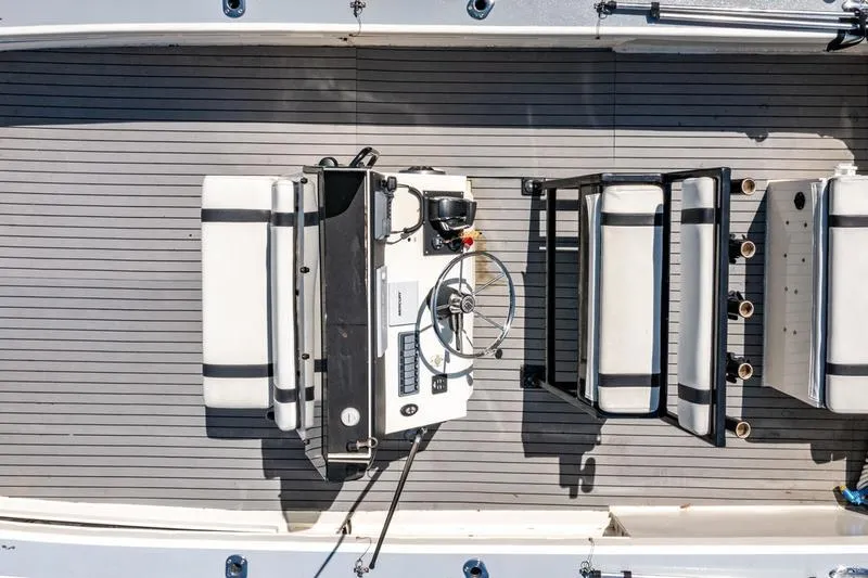 Slide: The Image of Overhead view of 2018 Encore Boat Works 25 Custom interior with steering console and seating. - 9
