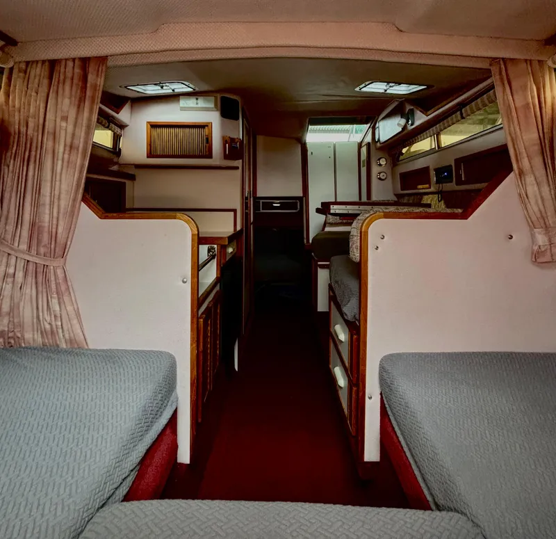 Slide: The Image of Interior of a 1989 Sea Ray Sundancer boat, featuring cozy seating and wood accents. - 10