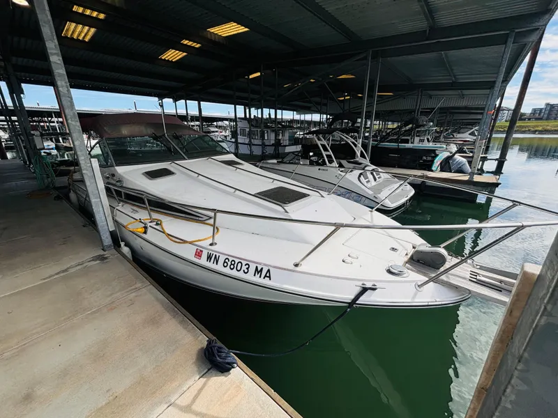 Slide: The Image of 1989 Sea Ray Sundancer docked in a covered marina. - 6