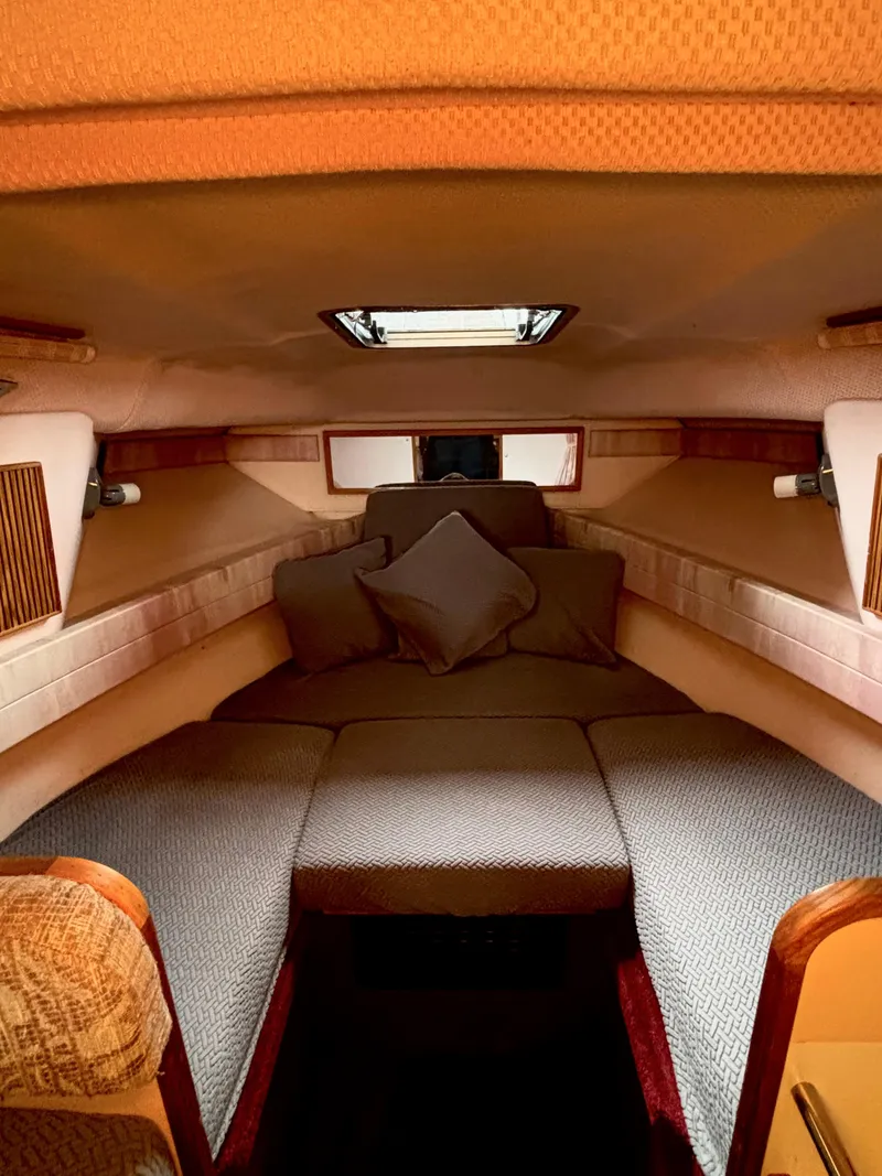 Slide: The Image of Interior cabin of 1989 Sea Ray Sundancer boat with cozy seating and cushions. - 9