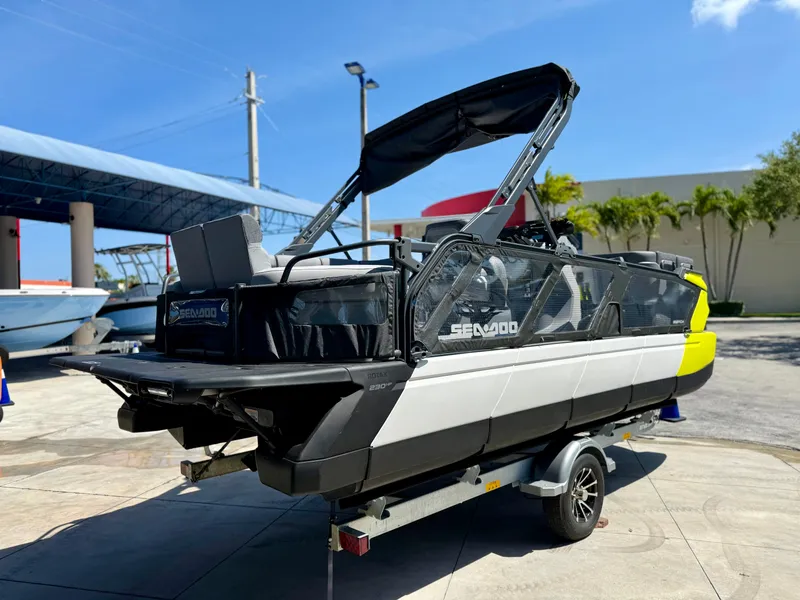 Slide: The Image of 2024 Sea-Doo Switch® Cruise 21 boat on trailer, parked outdoors under clear sky. - 4