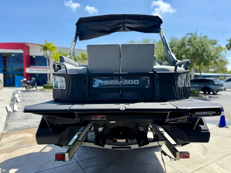 Slide: The Image of 2024 Sea-Doo Switch® Cruise 21 boat, rear view, parked outdoors on a sunny day. - 5