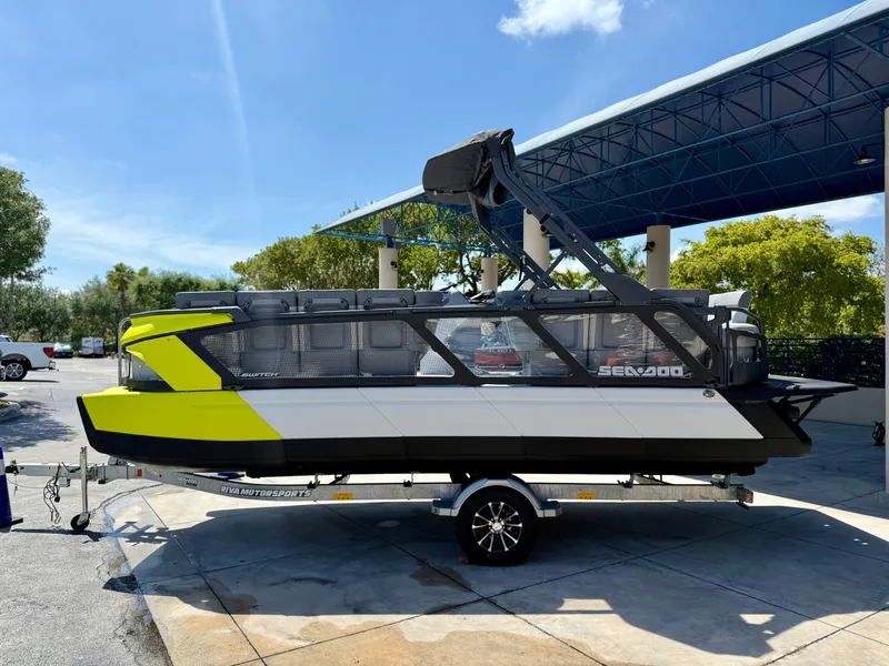 Slide: The Image of 2024 Sea-Doo Switch® Cruise 21 boat on trailer, vibrant yellow accents, parked outdoors. - 6