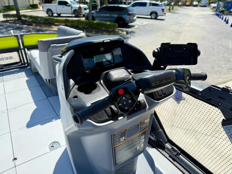Slide: The Image of 2024 Sea-Doo Switch® Cruise 21 dashboard with controls and steering wheel in a parking lot. - 8