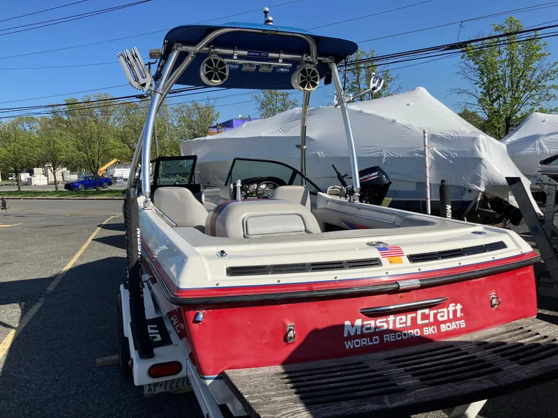 Slide: The Image of 1993 MasterCraft Prosport 205 ski boat with tower speakers, parked outdoors. - 3