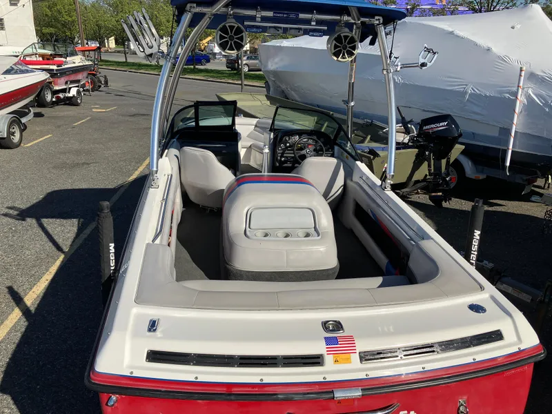 Slide: The Image of 1993 MasterCraft Prosport 205 boat with open seating and tower, parked outdoors. - 4