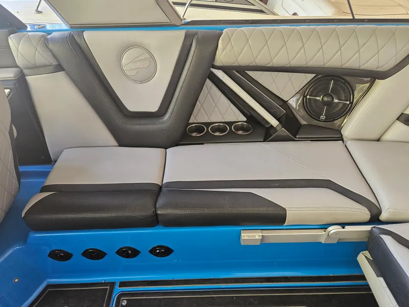 Slide: The Image of 2020 Tigé ZX25 interior with gray and black seating, cup holders, and speaker system. - 13