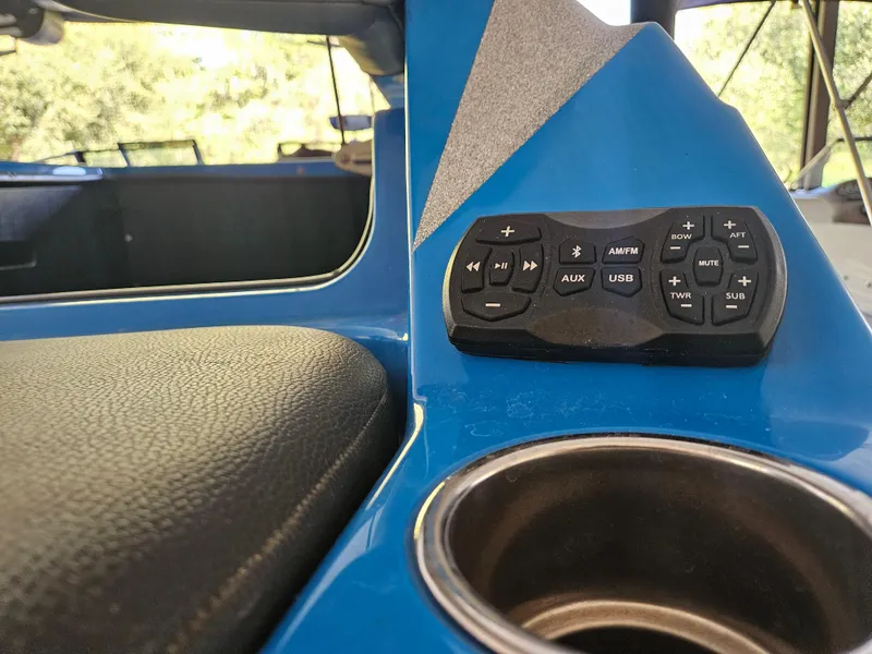 Slide: The Image of 2020 Tigé ZX25 boat interior with audio controls and cup holder. - 14