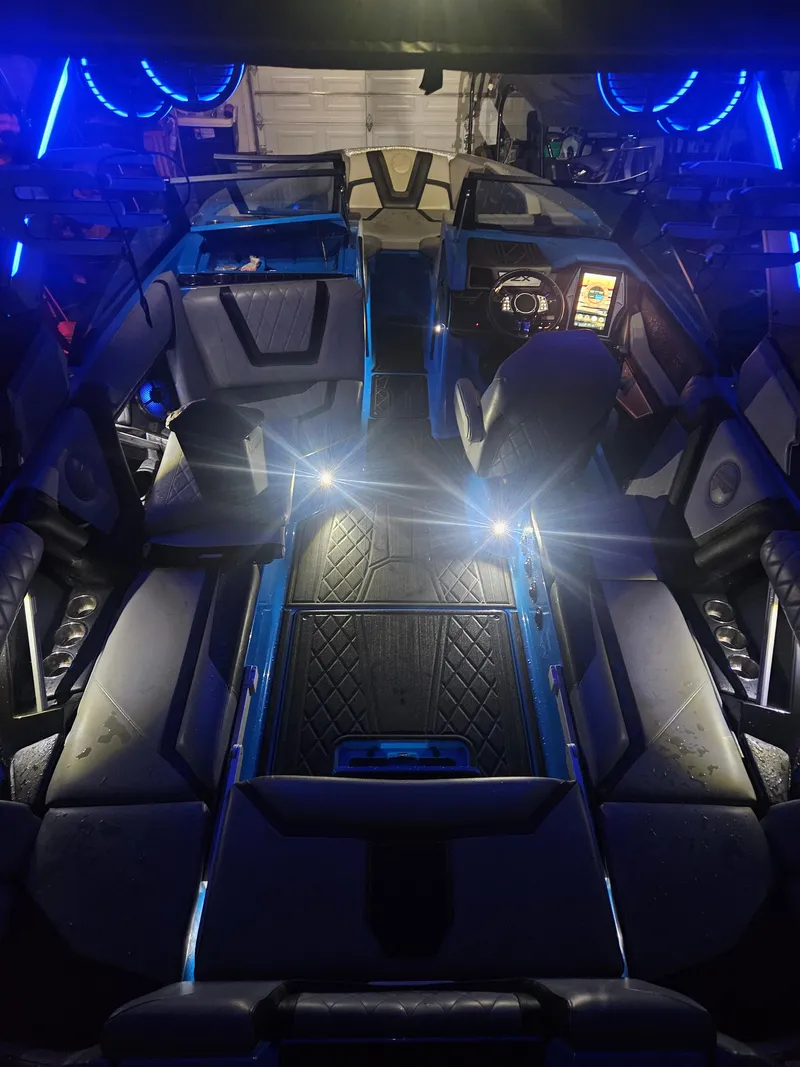 Slide: The Image of 2020 Tigé ZX25 boat interior with blue LED lighting and luxurious seating. - 21