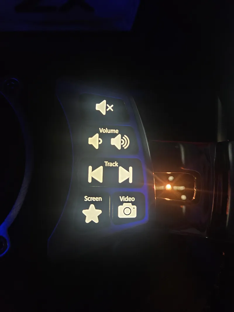 Slide: The Image of Control panel of a 2020 Tigé ZX25 boat with illuminated audio and video buttons. - 22