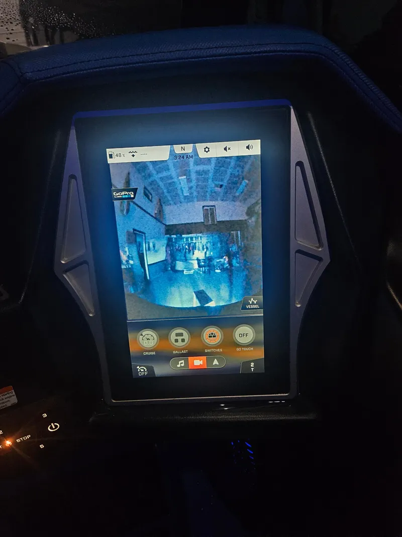 Slide: The Image of 2020 Tigé ZX25 touchscreen display with control interface, illuminated in blue light. - 24