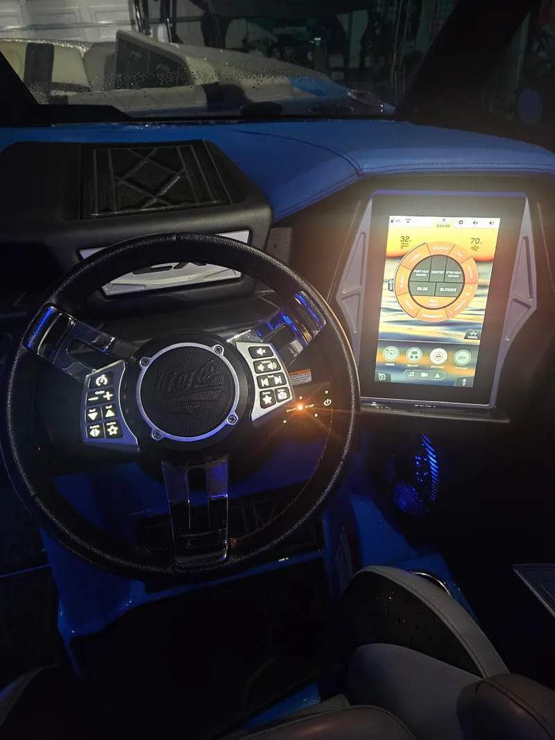 Slide: The Image of 2020 Tigé ZX25 dashboard with touchscreen and steering wheel controls. - 25