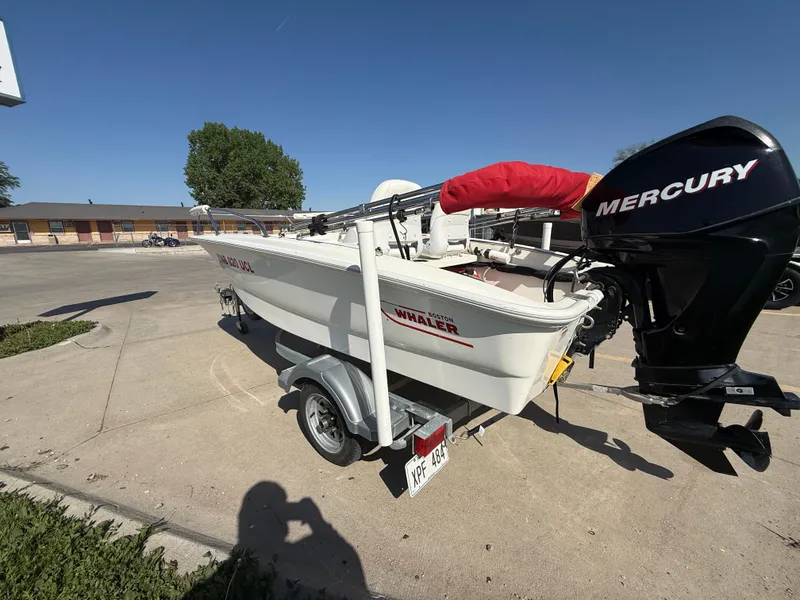 Slide: The Image of 2009 Boston Whaler 130 Super Sport boat with Mercury engine on a trailer. - 3