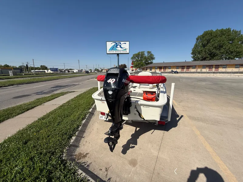 Slide: The Image of 2009 Boston Whaler 130 Super Sport with Mercury outboard motor parked on a sunny street. - 4
